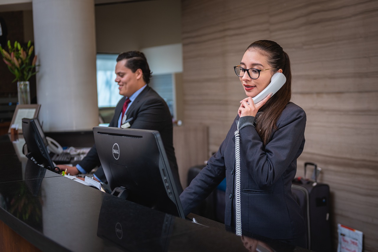 a hotel receptionist on a work phone