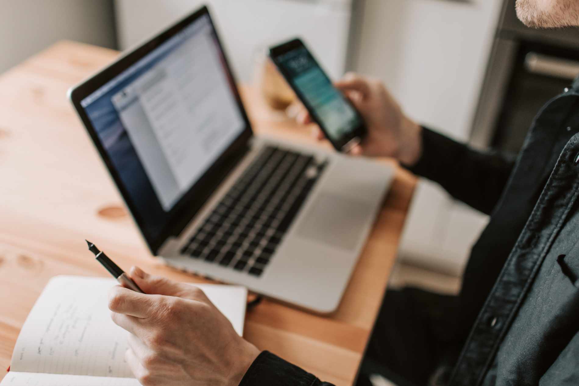 whatsapp or telegram on a phone, beside a work laptop