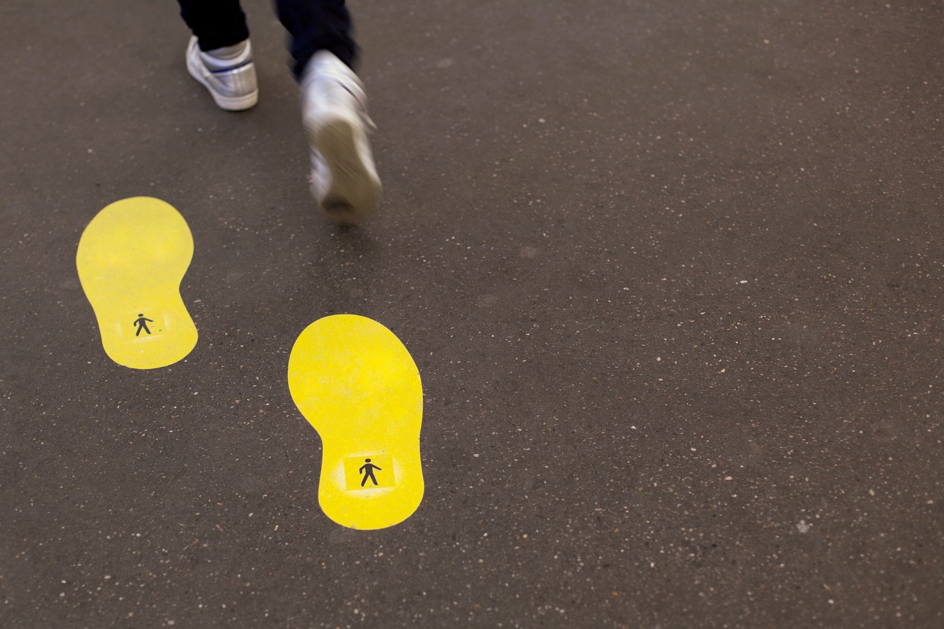 trainered feet leaving a yellow footprint behind