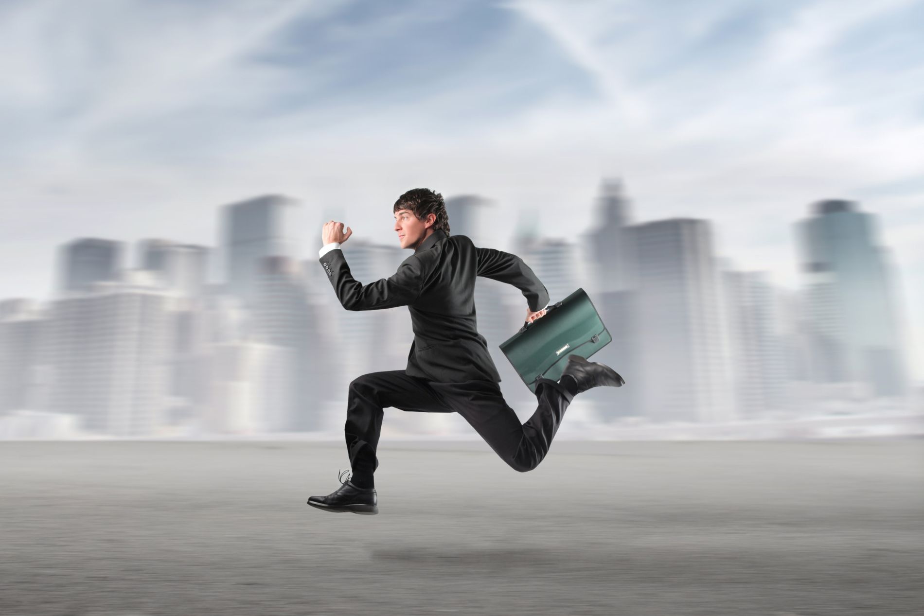 man in a suit with a briefcase, running at speed