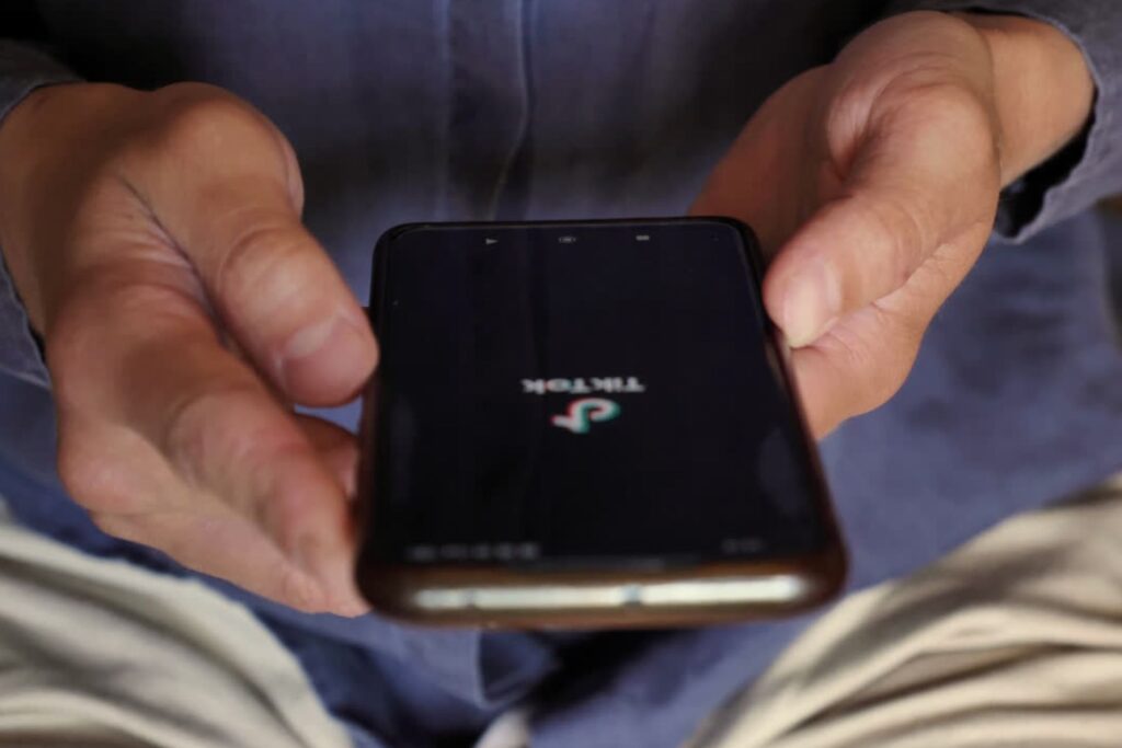 tiktok logo showing on a mobile phone being used