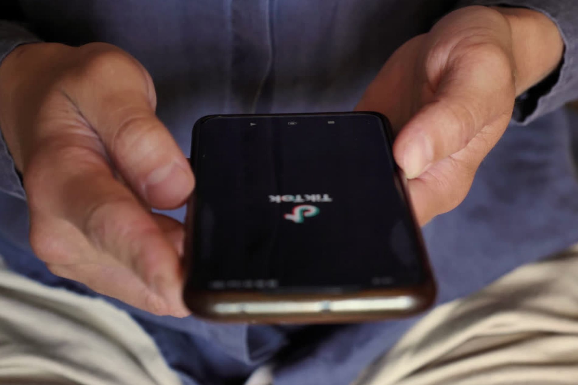 tiktok logo showing on a mobile phone being used