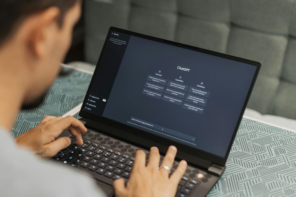 a man works at a laptop with ChatGPT search page displayed